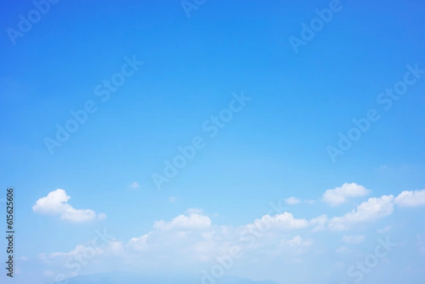 Fototapeta Blue sky background and white clouds soft focus and mountain, copy space horizontal shape.