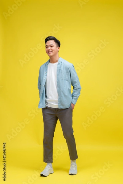 Fototapeta full body image of asian man posing on yellow background