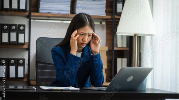 Fototapeta Stress chinese business woman doing bookkeeping analyst audit working papers, public offering, cash budget, accrued dividend, note payable, actual cost, aging schedule, intangible fixed asset