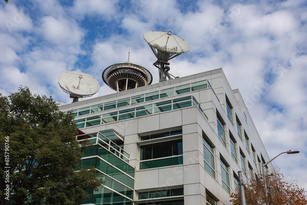 Fototapeta Generic office building with vintage satallites and top of space needle with cloudy sky
