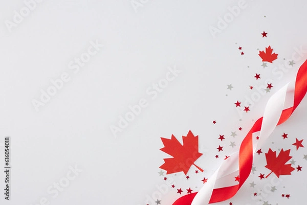 Fototapeta Victoria Day festivities concept in Canada. Top view flat lay of red maple leaves, stars confetti, satin ribbons on white background with empty space for text or greeting