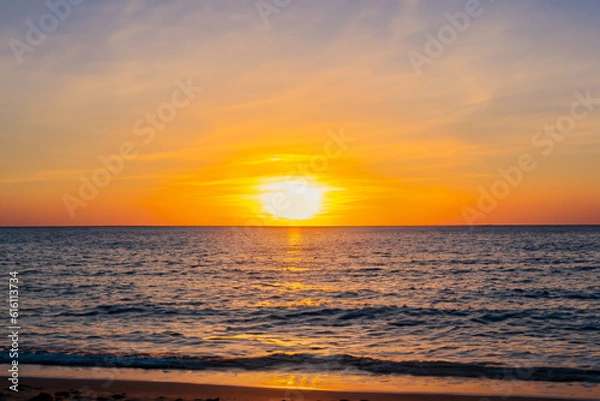Obraz Beach sunset Head to a beach and witness the golden sun setting over the sea
