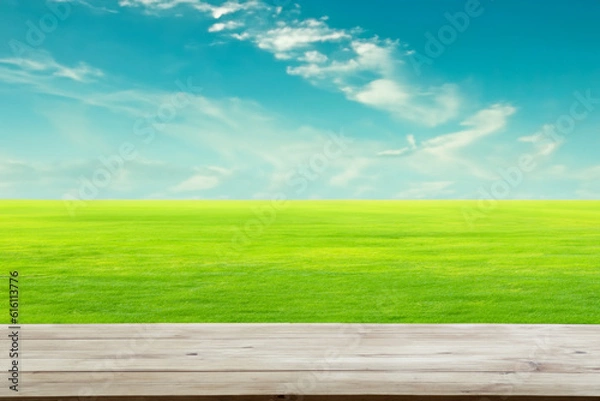 Fototapeta Green Grass Field in the Background with a Clean Wooden Table in the Foreground
