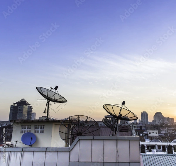 Obraz Satellite dish on the roof at sunset