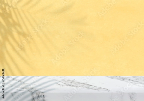 Obraz Empty white marble tabletop with leaves shadow on textured pastel yellow wall for product presentation
