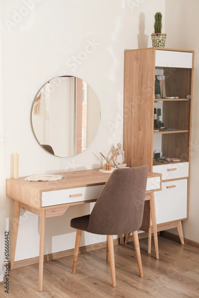 Fototapeta modern interior of bedroom, dressing table with mirror and soft upholstered chair. trendy minimal style decor. vertical shot. 
