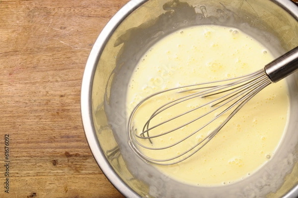 Fototapeta Manual whisk mixing cream and egg