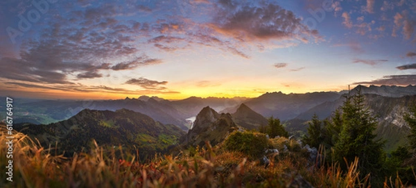 Fototapeta Federispitz, Speer, Mattstock, Säntis and many other 
 mountain tops at dawn in Switzerland.