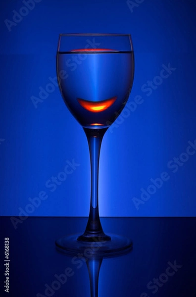 Fototapeta wineglass with wine on the color background