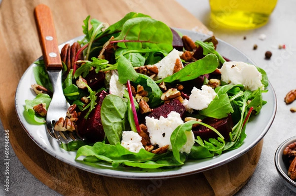 Fototapeta Fresh Salad with Beetroot, Feta Cheese, and Pecans, Healthy Vegetarian Meal on Grey Background