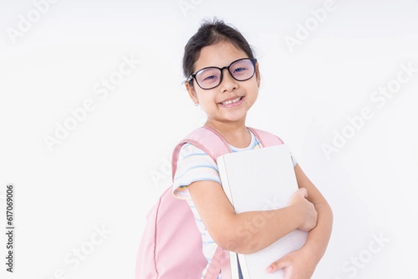 Fototapeta Asia kids girl smile happiness wearing glasses with a pink backpack learn at school isolated on white background with copy space. Concepts back to school, learning, education.