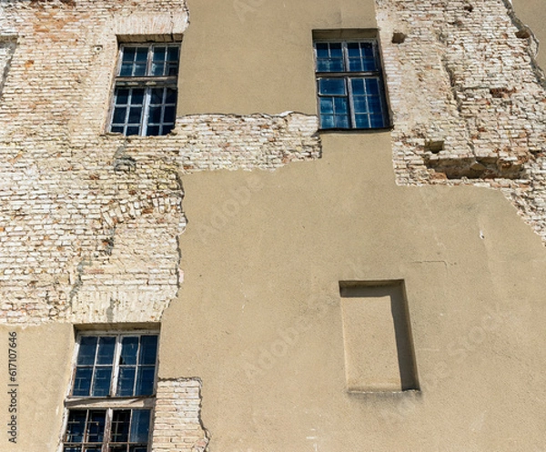 Obraz Part of the wall of an old building with damaged plaster