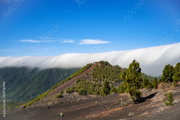 Obraz Clouds move over the mountain slope of Cumbre Nueva and flow into the valley like a waterfall, La Palma, Canary, Spain, Europe