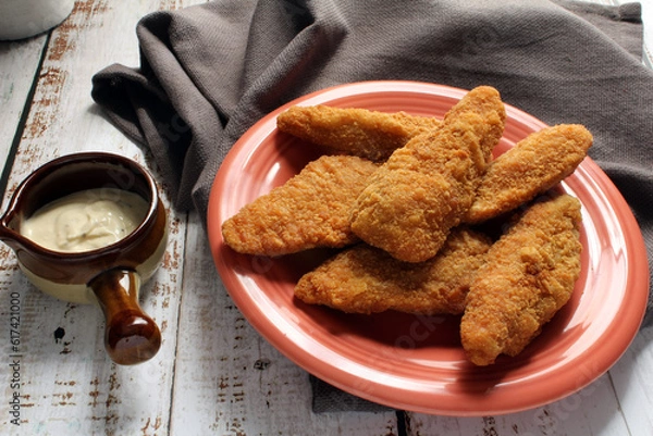 Obraz A plate of chicken tenders served with a creamy dip