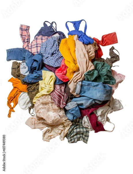 Fototapeta Isolated pile of used clothes on a light background. Second hand for recycling