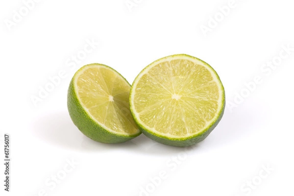 Fototapeta Two halfs of citrus lime on the white background.