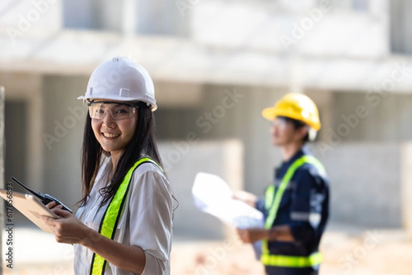 Fototapeta Progressive Construction Project Management with Engineers and Tablets - Blueprint Planning and On-Site Expertise