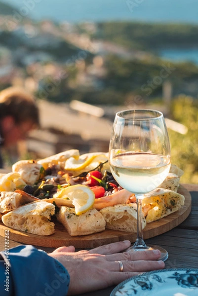 Obraz Luxury seafood board and a glass of wine with amazing sea view of Kvarner bay and Lošinj archipelago of Croatia islands