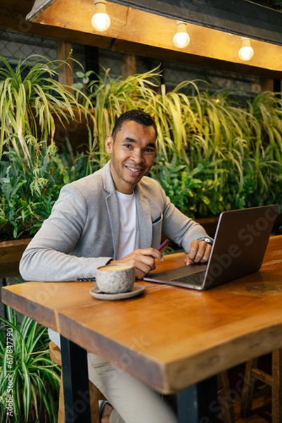 Obraz Man working on laptop at cafeteria