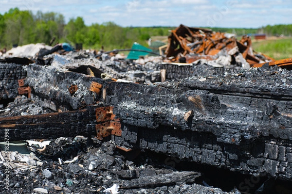 Fototapeta The conflagration. charred wood fragments, rusted and crumpled steel parts and all sorts of junk