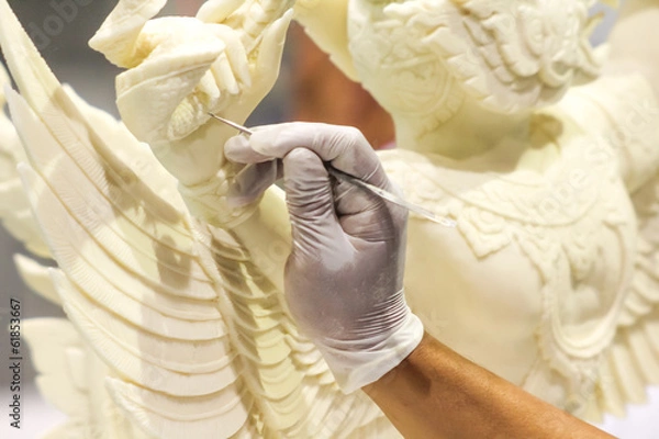 Obraz Close up of hand carving white chocolate