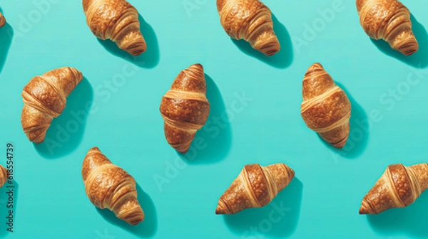 Obraz Delicious freshly baked crispy croissants on a turquoise minimal background. Flatlay pattern. Generative AI.