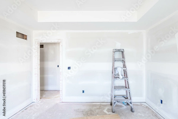 Fototapeta High and dirt ladder put by unfinished drywall on the floor in empty room at construction site. New build property project. Home improvement, house renovation concept. Ready for Interior and paintwork