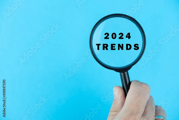 Fototapeta Focused on trend for next year 2024 concept. Words 2024 trends under magnifying glass. Card design. 