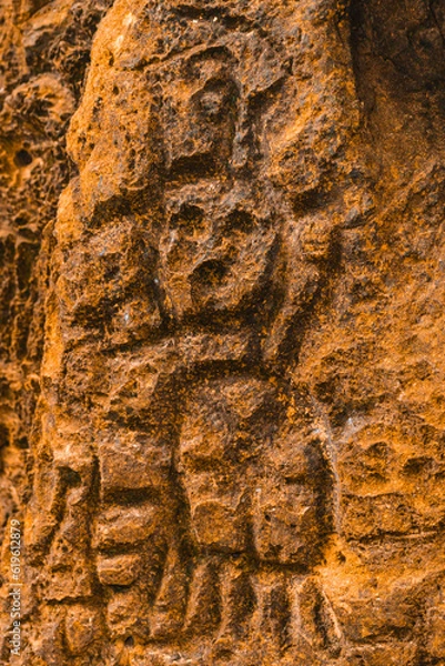 Fototapeta Rock texture hieroglyphs Taino art carved in the wall of the cave in Cueva del indio arecibo