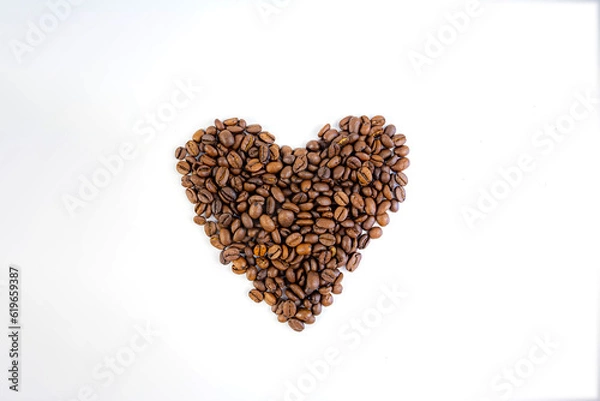 Fototapeta coffee beans folded into a heart on a white background