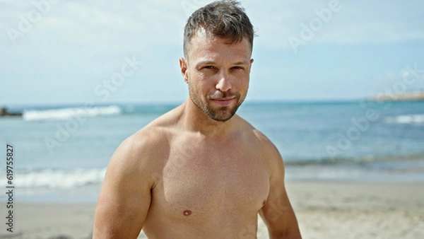 Obraz Young man tourist smiling confident standing at the beach