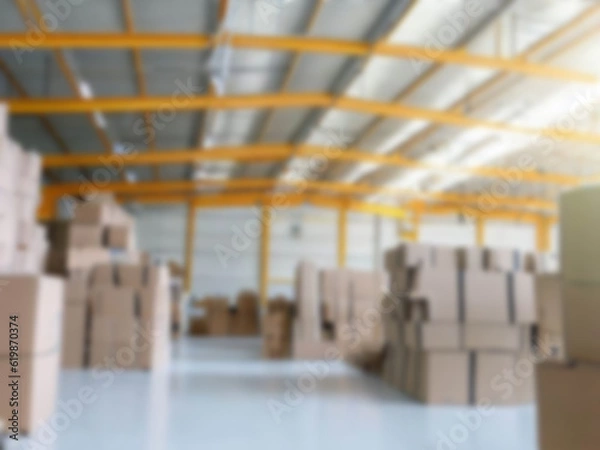 Fototapeta Blurred  A warehouse where the goods are packed in a large number of brown cardboard boxes.