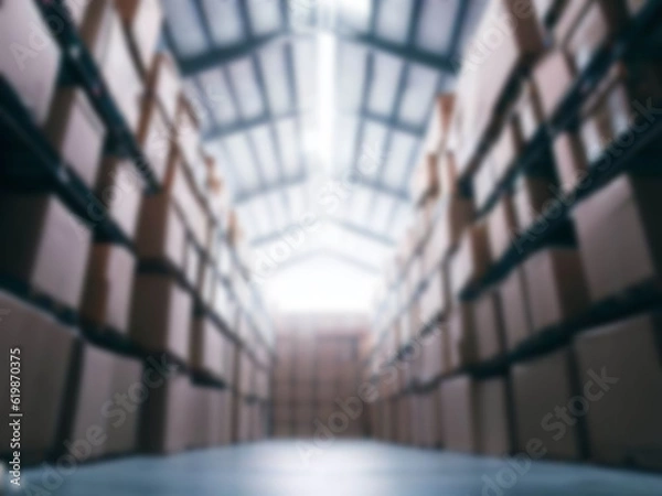 Fototapeta Blurred  A warehouse where the goods are packed in a large number of brown cardboard boxes.