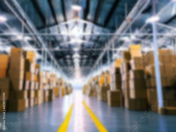 Fototapeta Blurred  A warehouse where the goods are packed in a large number of brown cardboard boxes.