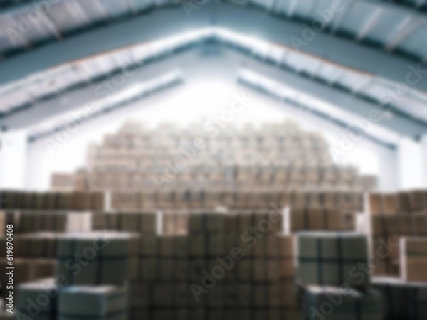 Fototapeta Blurred  A warehouse where the goods are packed in a large number of brown cardboard boxes.