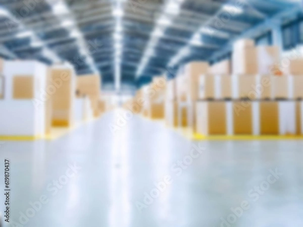 Fototapeta Blurred  A warehouse where the goods are packed in a large number of brown cardboard boxes.