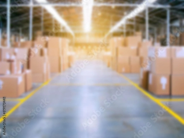 Fototapeta Blurred  A warehouse where the goods are packed in a large number of brown cardboard boxes.