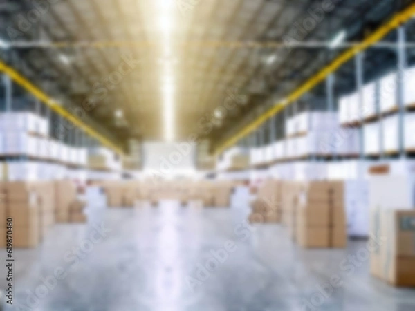 Fototapeta Blurred  A warehouse where the goods are packed in a large number of brown cardboard boxes.