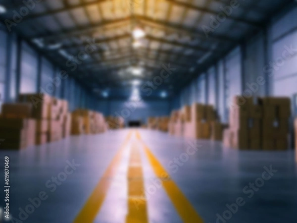 Fototapeta Blurred  A warehouse where the goods are packed in a large number of brown cardboard boxes.