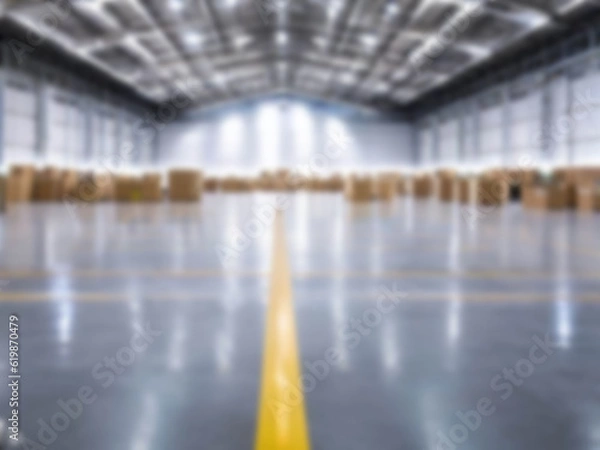 Fototapeta Blurred  A warehouse where the goods are packed in a large number of brown cardboard boxes.