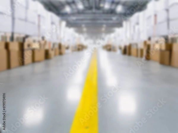 Fototapeta Blurred  A warehouse where the goods are packed in a large number of brown cardboard boxes.