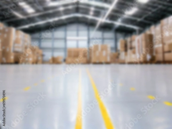 Fototapeta Blurred  A warehouse where the goods are packed in a large number of brown cardboard boxes.