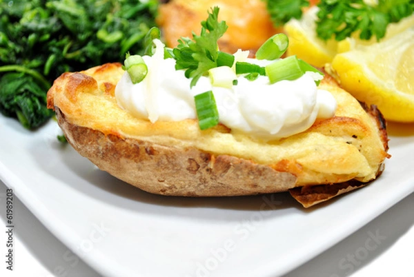 Fototapeta Twice Baked Potato with Fresh Sour Cream and Chives