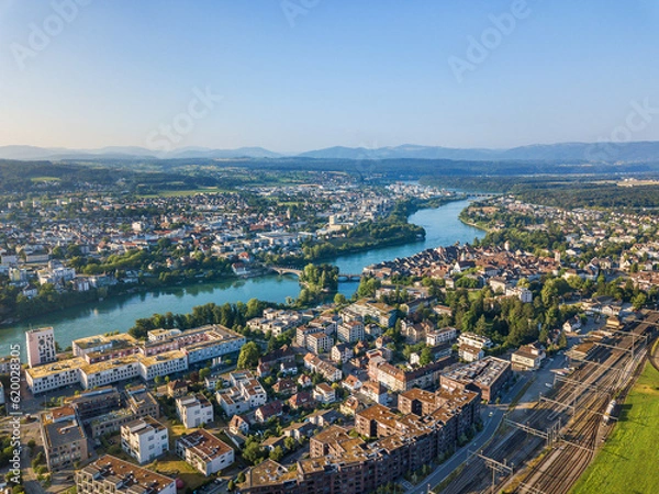 Fototapeta Aerial image of Rheinfelden towns in Switzerland and Germany connected with a bridge over the river Rhine