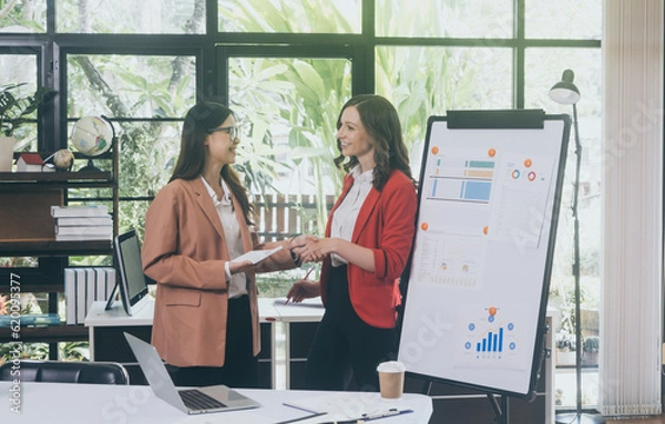 Fototapeta Businesswoman Using Computer in Modern Office with Colleagues.