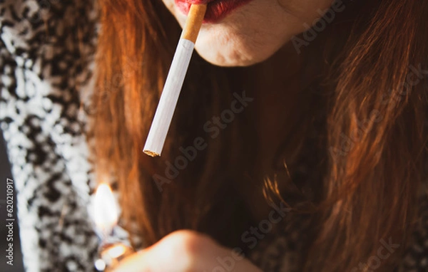Obraz Frau zündet sich eine Zigarette an