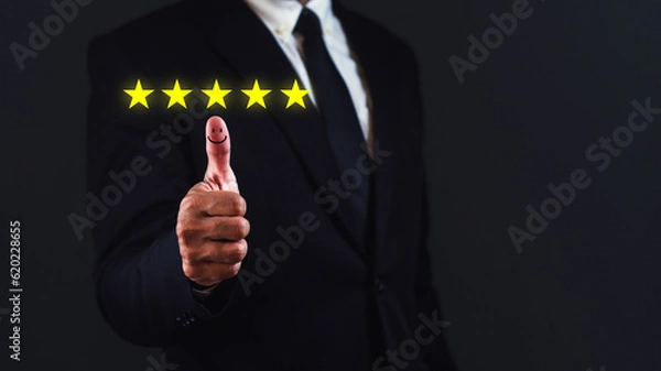 Fototapeta Customer satisfaction concept. Businessman show thumb up with positive emotion happy face and five stars.