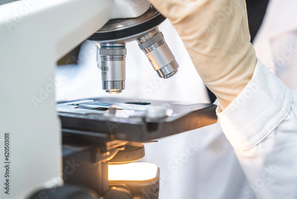 Fototapeta microscope tool technology using in laboratory, scientific equipment for microbiology science research, medicals scientist analysing experiment in term of biology or biotechnology for medicine test