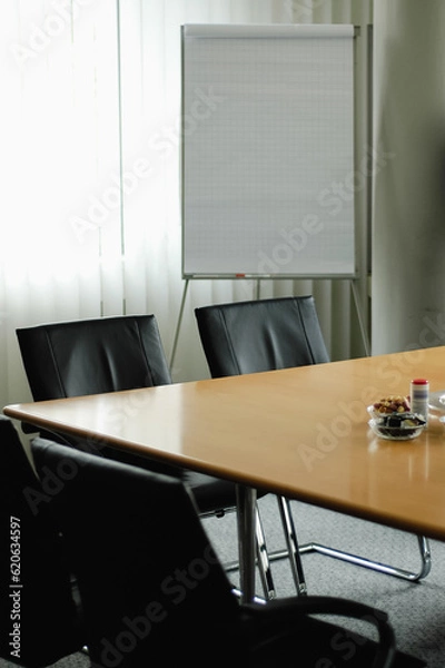 Fototapeta Empty conference room in hotel for business meeting with wooden table and vertical blinds during day