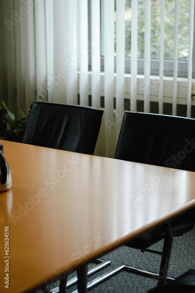 Fototapeta Empty conference room in hotel for business meeting with wooden table and vertical blinds during day